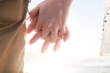 Fototapeta premium Couple, man and woman holding hands. Engagement ring. Romantic. Details. Close up