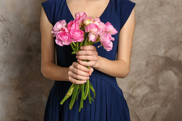 Woman holding beautiful bouquet of fresh ranunculus flowers