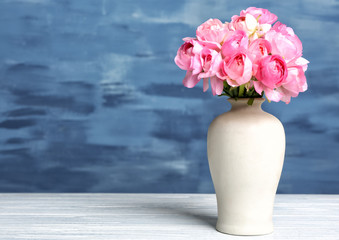 Vase with beautiful bouquet of ranunculus flowers on table
