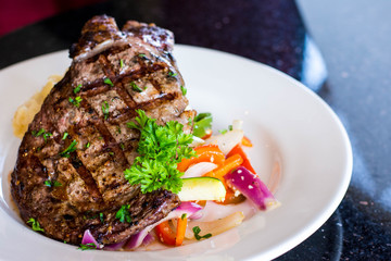 Grilled steak with veggies on the plate