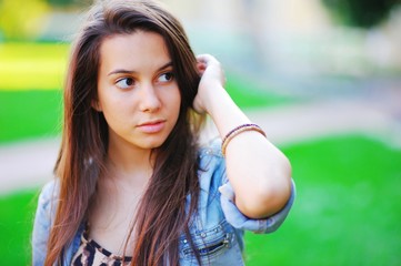 portrait of a beautiful brown-haired girl with big eyes and a calm look.