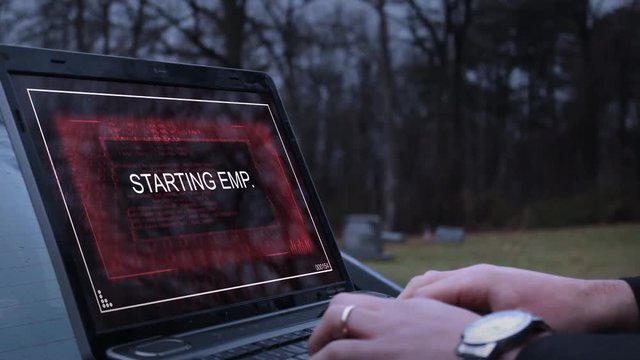 A secret agent or operative activates an EMP on his laptop and flees