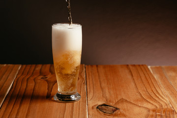 Glass of beer on wood table