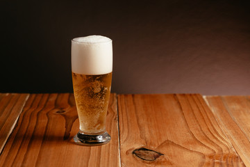 Glass of beer on wood table