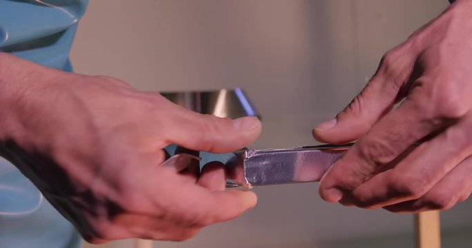 Making the glass. Making the glass for window on manufacture. Glass reinforcied by tape. Worker taped the glass. After grinding worker using reinforcing tape taping the corner of the glass. Paste