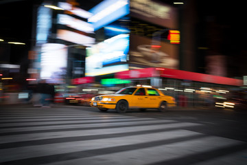 Fototapeta na wymiar Fast moving taxi in city
