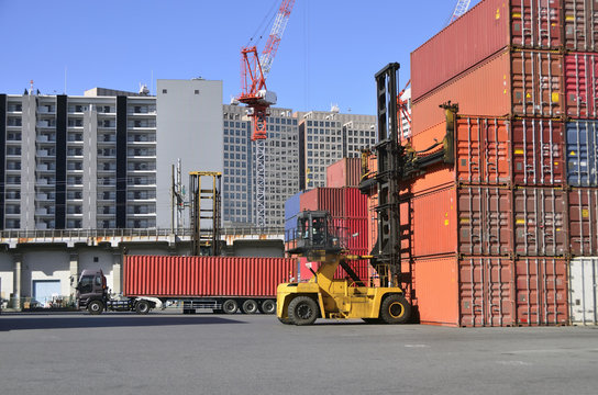 Toplifter handling cargo container loading to container trailer in import export logistic zone
