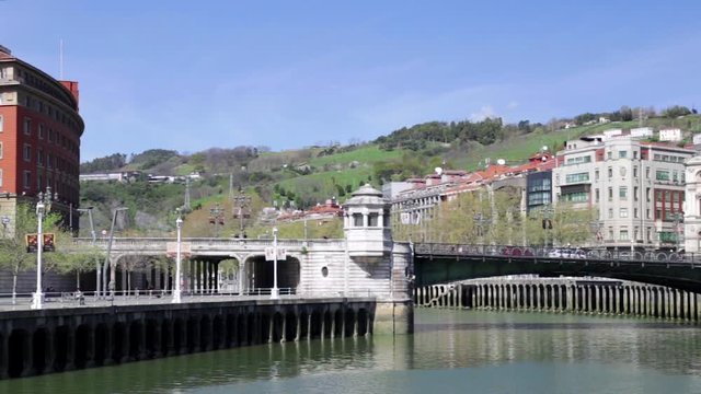 Bilbao city town hall and the Nervion River in a sunny day. Horizontal pan.