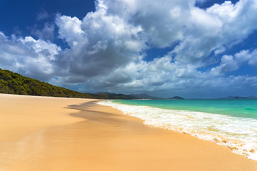 Beautiful tropical beach with piqturesque cloudscape