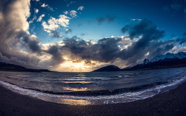 Waves in a sunset on black sand beach, Ushuaia, Argentina
