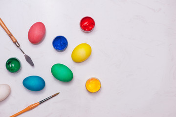 Happy Easter! Friends painting Easter eggs on table.