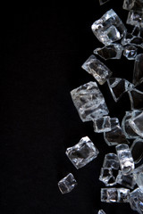 Ice cube background isolated on black with copy space.