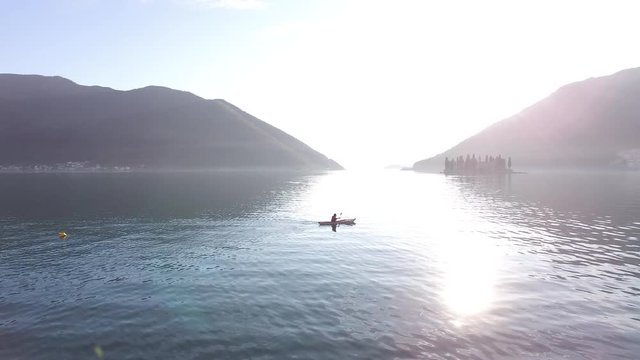 Kayaks in the lake. Tourists kayaking on the Bay of Kotor, near the town of Perast in Montenegro. Aerial Photo drone.