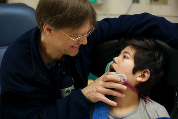 Disabled little boy in doctor's office getting check up