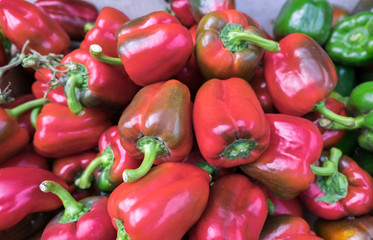 Red and green bell peppers for sale at the city farmers market