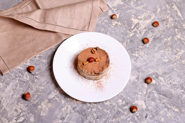 Chocolate mini cake on a plate with nuts