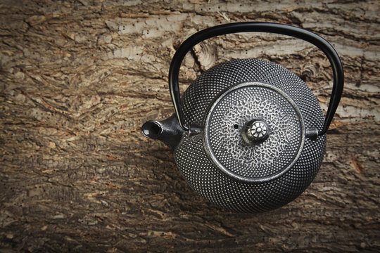 Teapot on a wooden background photo top view