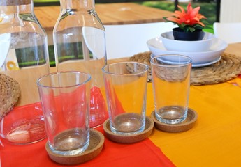 Dishes with Glass and Glass Bottle on Table