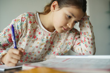 Young girl being busy doing homework