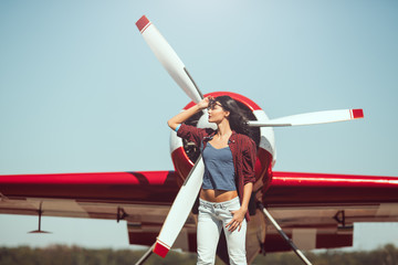Woman pilot and airplane - obrazy, fototapety, plakaty