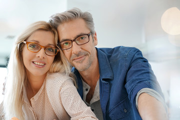 Portrait of happy middle-aged couple with eyeglasses