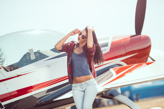 Woman pilot and airplane