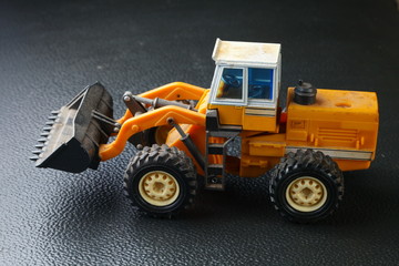 Old and dirty bulldozer die cast toy model represent the construction toy model concept related idea.