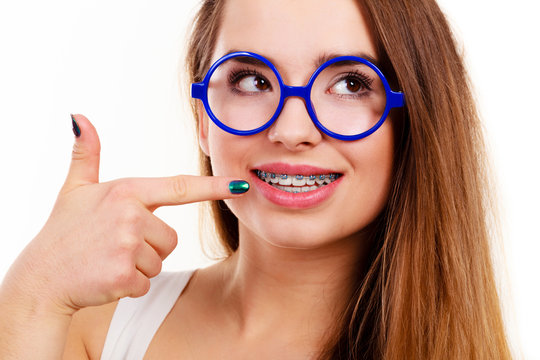 Nerdy woman showing her teeth with braces