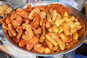 The meal of potato and banana fried. Delicious snacks fried in hot oil.