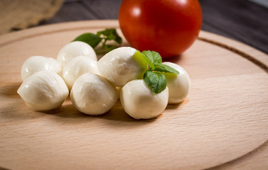 Mini mozzarella on a wooden background