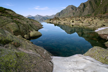 Fototapeta na wymiar A small lake on the Baikal ridge