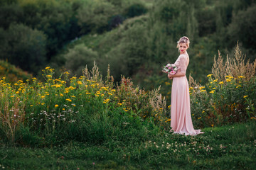 Fototapeta premium Bride in a pink dress. Wedding in the mountains.