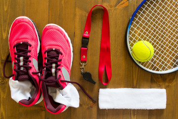 Set of things for playing tennis on a wooden background