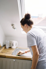 Young woman do the cleaning in modern minimal kitchen.