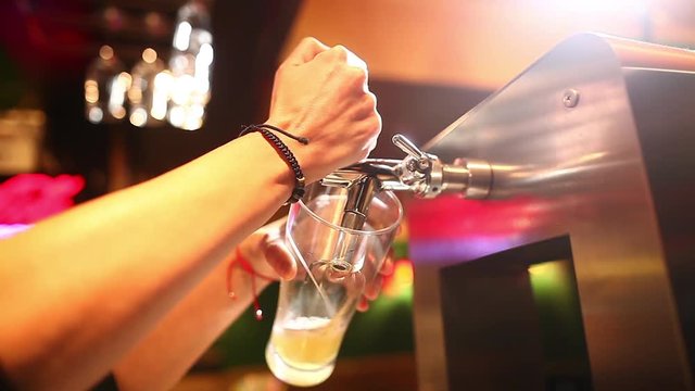 Color footage of a waiter pouring draught beer into a glass, in a pub or restaurant. 