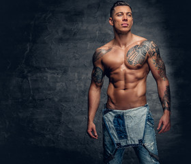 Studio portrait of handsome muscular male fitness model.