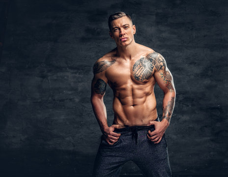 Muscular man fitness model with tattoo on his chest.