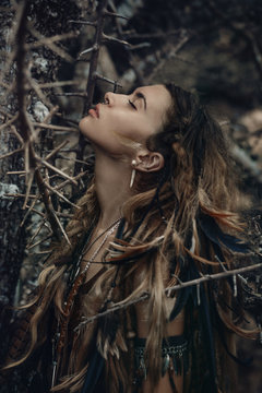 Woman in forest with eyes closed