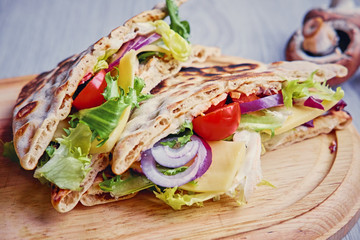 Pita bread with ham, cucumber and tomatoes.
