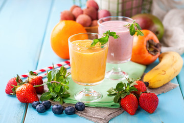 Orange persimmon blueberry smoothie   and fruits. Selective focus. Copy space. Top view