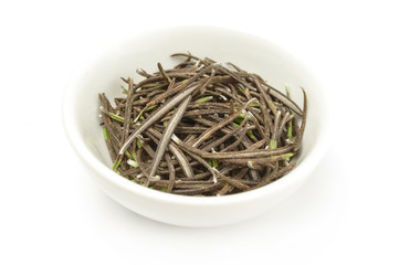 Dry leaves rosemary in plate isolated on white background cutout