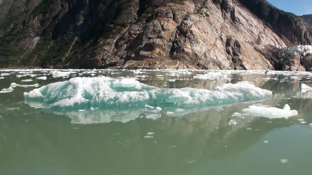 Moving Ice Floes on background of mountain and water Pacific Ocean in Alaska. Amazing landscapes. Beautiful rest and tourism in a cool climate. Unique picture of nature in America.