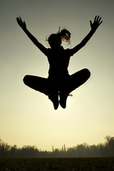 Silhouette of girl jumping. Backlit. Joy. Freedom