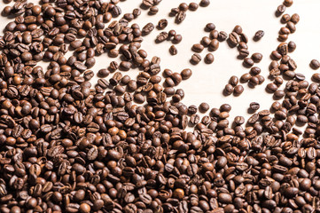 Top view of roasted coffee beans on white background