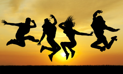 Fototapeta na wymiar Silhouette jumping happiness people on sunset