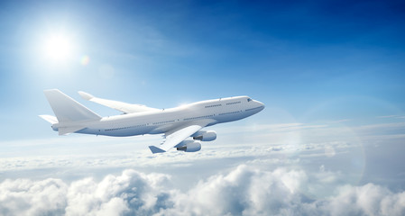 Airplane flying above clouds - obrazy, fototapety, plakaty