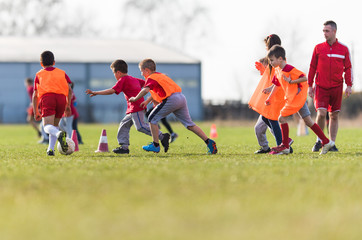 Obraz premium Kids soccer football - children players match on soccer field