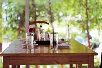 Interior wooden table and chair and nature green garden background