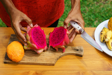 girl peel red dragon fruit. culinary workshop. cooking class