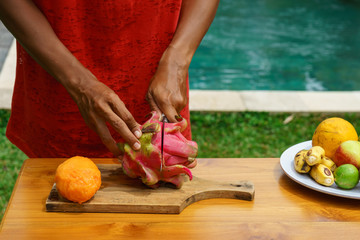 girl peel red dragon fruit. culinary workshop. cooking class